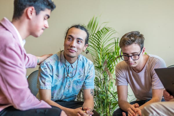 Three young men provide support